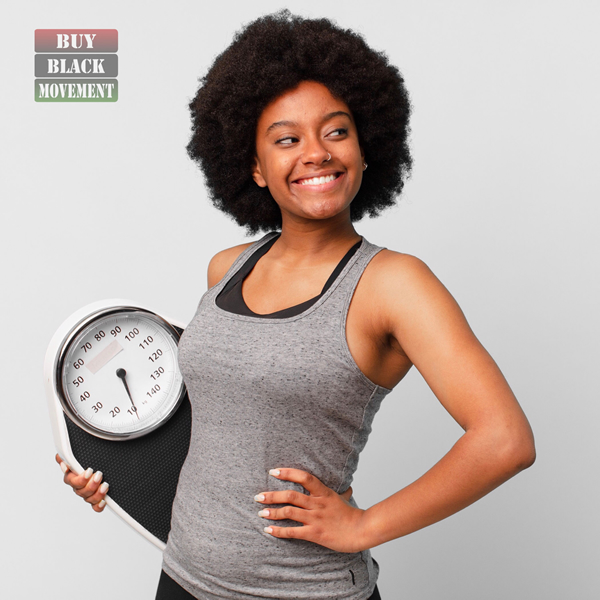 Black woman holding scale